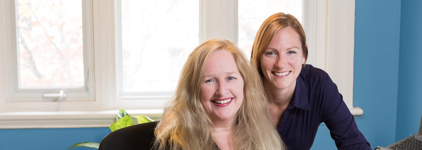 Evey and Heather smiling at the camera. They head up IDC's apostille service team.